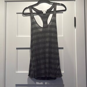 Shiny tank top made from a sleek blend of 85% rayon and 15% lurex.